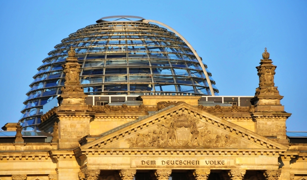 Foto der Reichstagskuppel und des Reichstagsportals mit der Inschrift "Dem deutschen Volke"